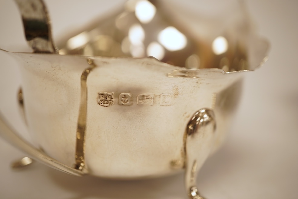 A pair of 1930's silver sauceboats, with cut borders, Barker Brothers Silver Ltd, Birmingham, 1935 and 1938, length 14.6cm, 5.8oz.